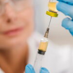 high-angle-defocused-female-scientist-using-syringe (1)